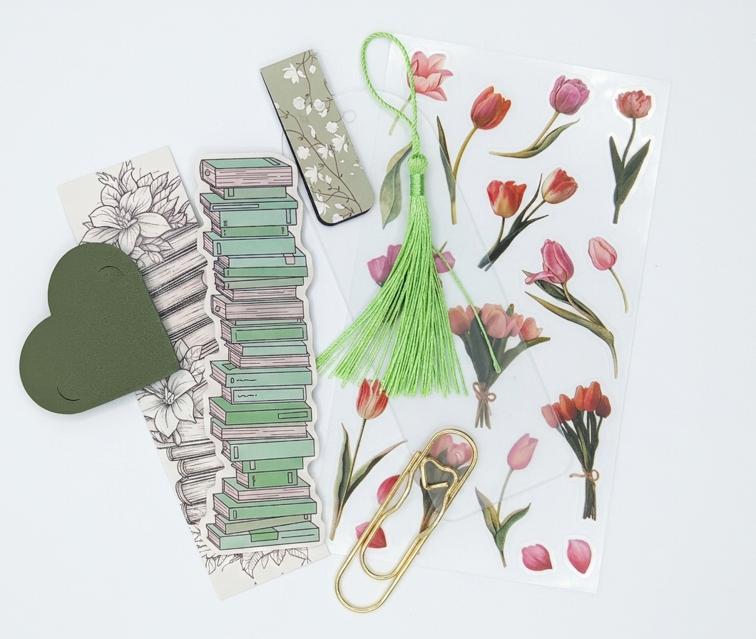 Image contains colorful bookmark, giant paperclip, coloring bookmark, leather heart bookmark, DIY Acrylic bookmark with tassel, magnetic bookmark, and sheet of stickers.